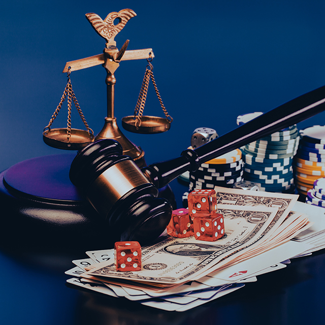 judge gavel and set of playing card with dices on reflective table