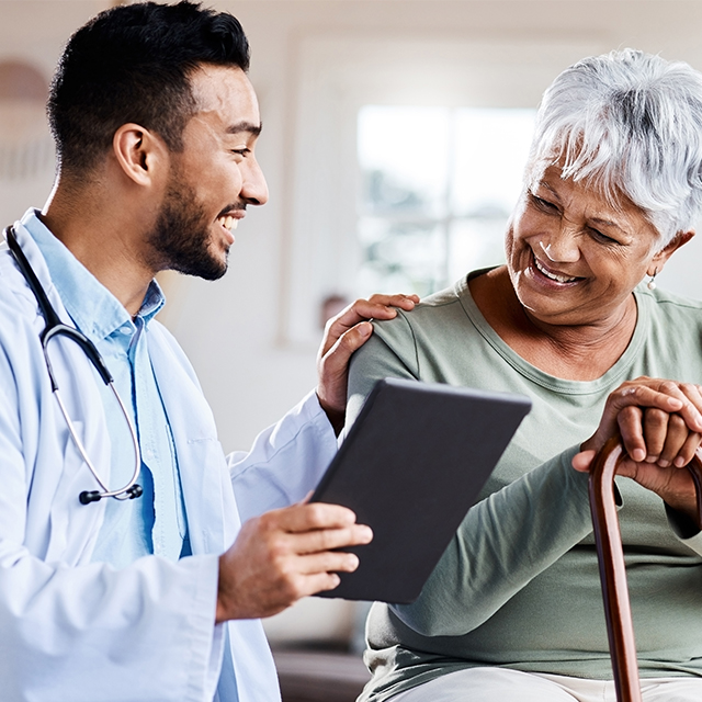 Shot of a young doctor sharing information from his digital tablet with an older patient stock photo