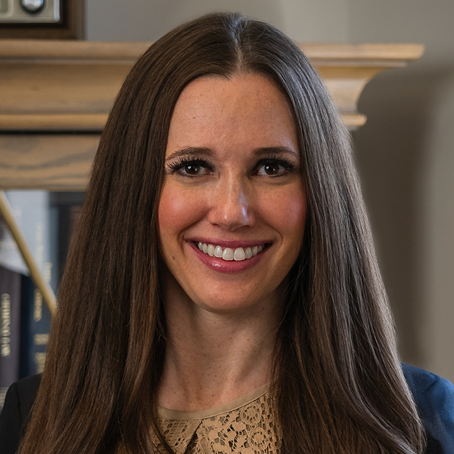 Marianne K Shanor headshot. She's smiling while looking at the camera