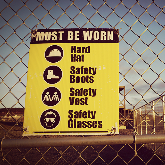 A safety sign in front of an oil production site.