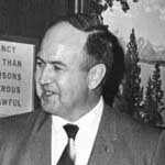 Stanley K. Hathaway smiling at an event in a historical photo