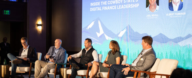 Panelists seated on stage at Wyoming Blockchain Symposium