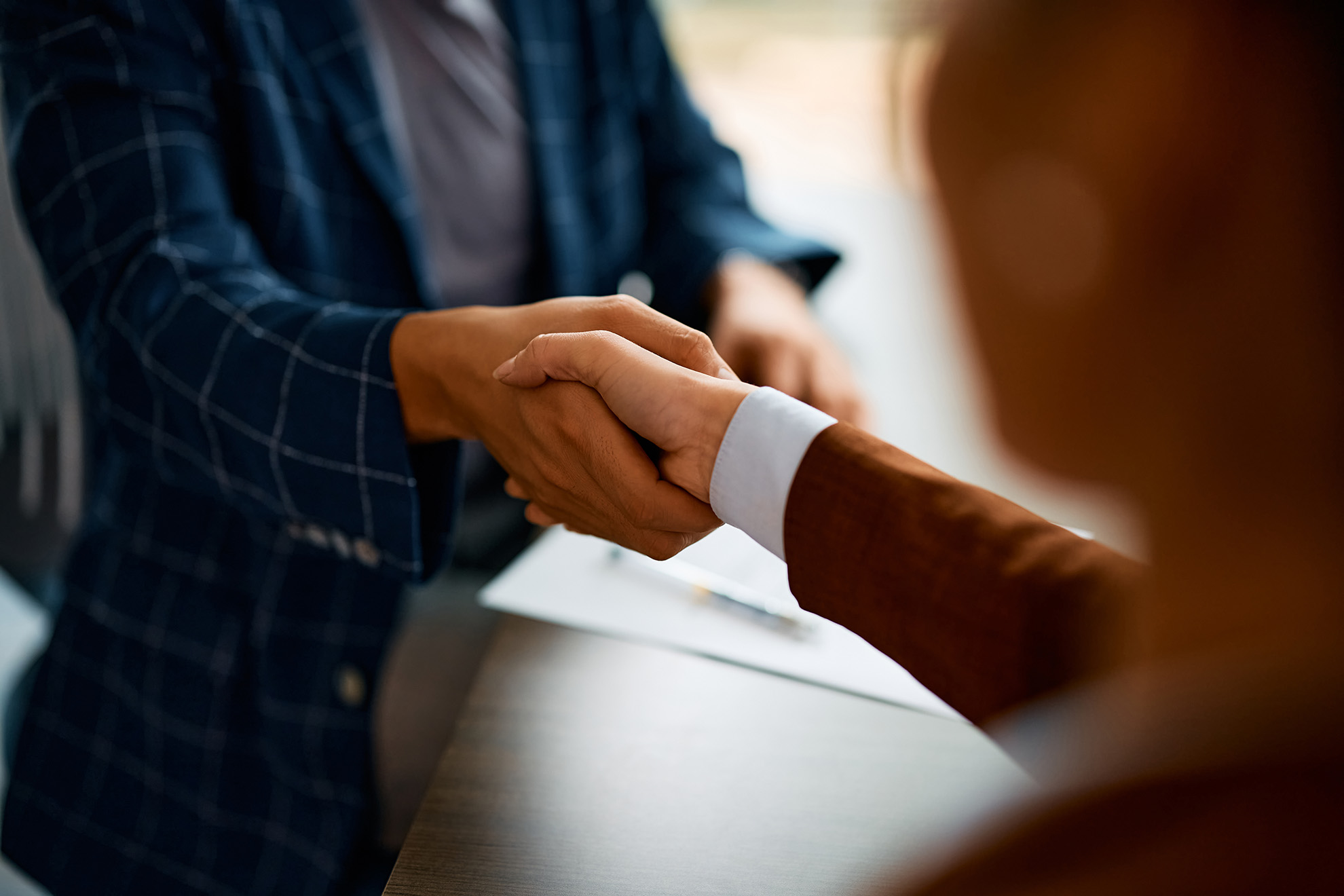 Mediation meeting handshake between parties reaching agreement
